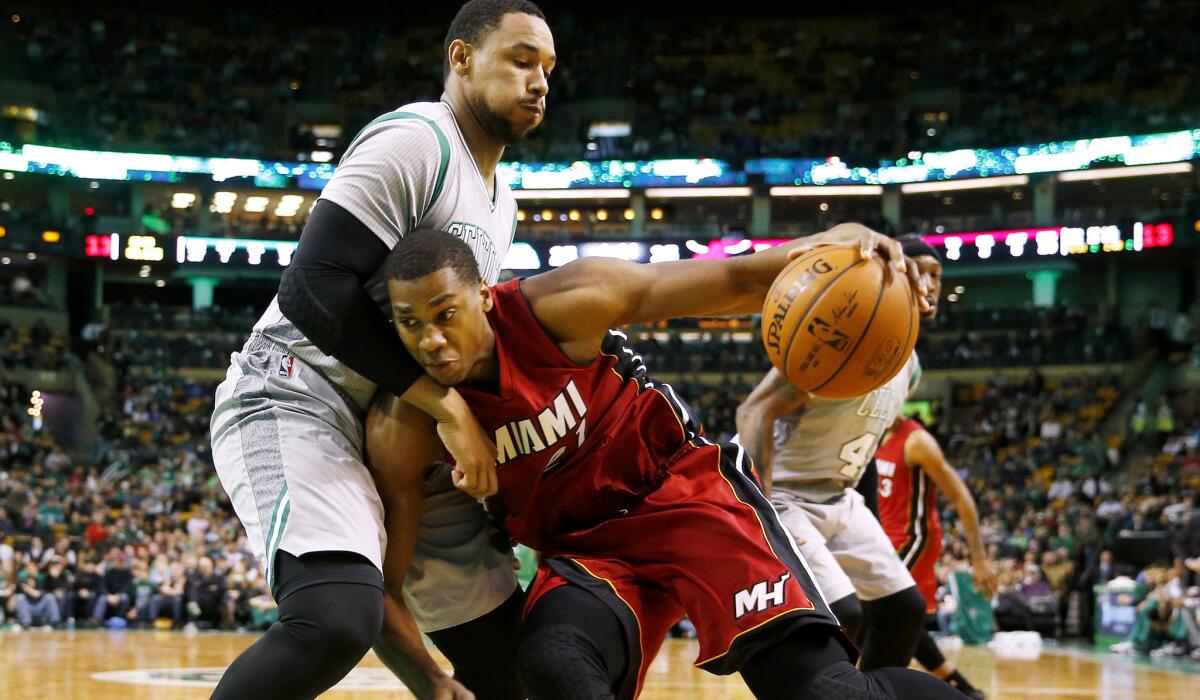 Heat center Hassan Whiteside tries to drive past Celtics forward Jared Sullinger.