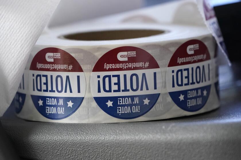FILE - A roll of "I Voted!" stickers are shown, Oct. 6, 2020, at the Miami-Dade County Elections Department in Doral, Fla. A Florida man has been arrested on forgery and fraud charges after authorities say he cast a ballot for his deceased father in the 2020 election. (AP Photo/Wilfredo Lee, File)