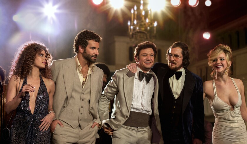 Comcast this week will begin selling through its electronic store movies from Sony Pictures Entertainment, including "American Hustle," starring (from left) Amy Adams, Bradley Cooper, Jeremy Renner, Christian Bale and Jennifer Lawrence.
