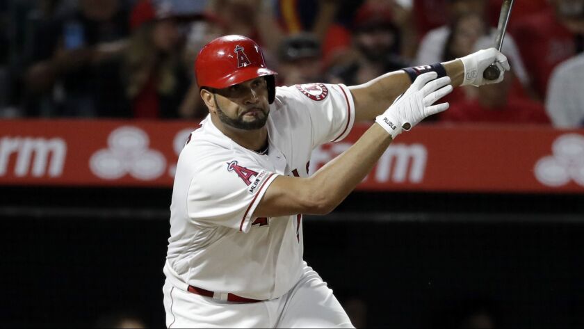 Albert Pujols hits a two-run single in the fifth inning during the Angels' 9-6 victory over the Houston Astros on Monday.