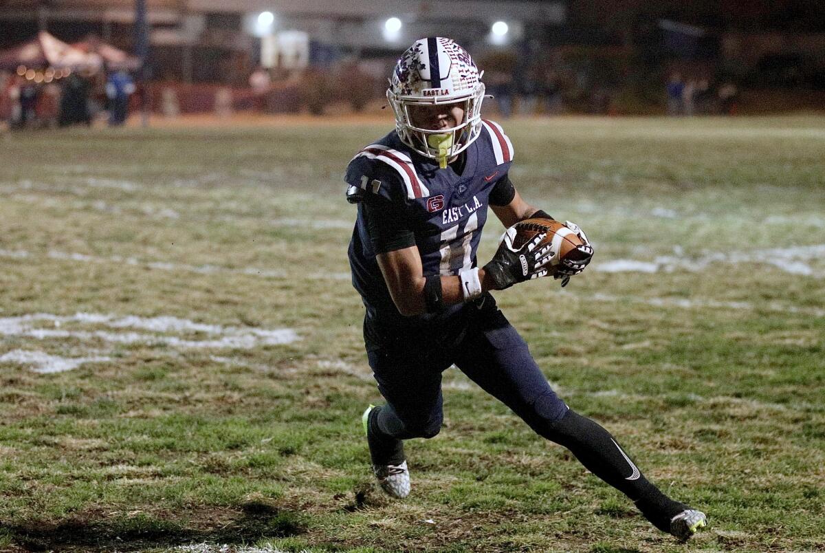 Garfield wide receiver Paul Ramos runs after making a catch against Gardena in the City Section Open Division semifinals.