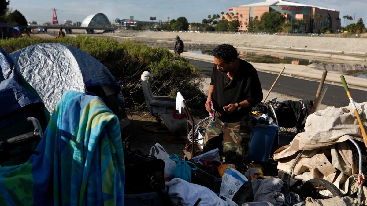 Joe Godoy, 59, at his camp Tuesday along the Santa Ana River in Anaheim. Orange County leaders Thursday approved a plan to provide motel vouchers, food and other services for about 400 homeless people living in encampments.