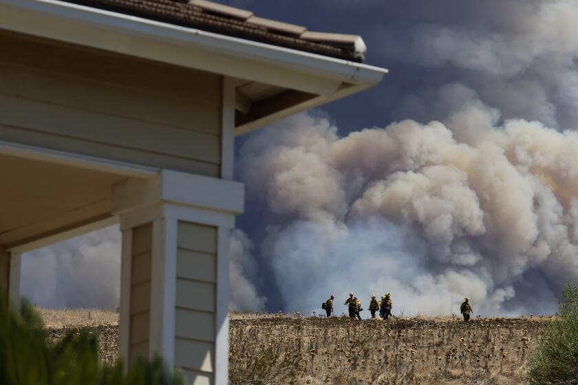 TRABUCO CANYON CALIF SEPTEMBER 10, 2024 - Fire crews keep a watchful eye on the Airport fire in the community of Ranch Santa Margarita on Tuesday, Sept. 10, 2024. The Airport fire has charred more than 9,000 acres. (Allen J. Schaben / Los Angeles Times)