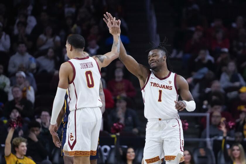 USC guard Isaiah Collier high fives guard Kobe Johnson during the team's win over Cal Wednesday