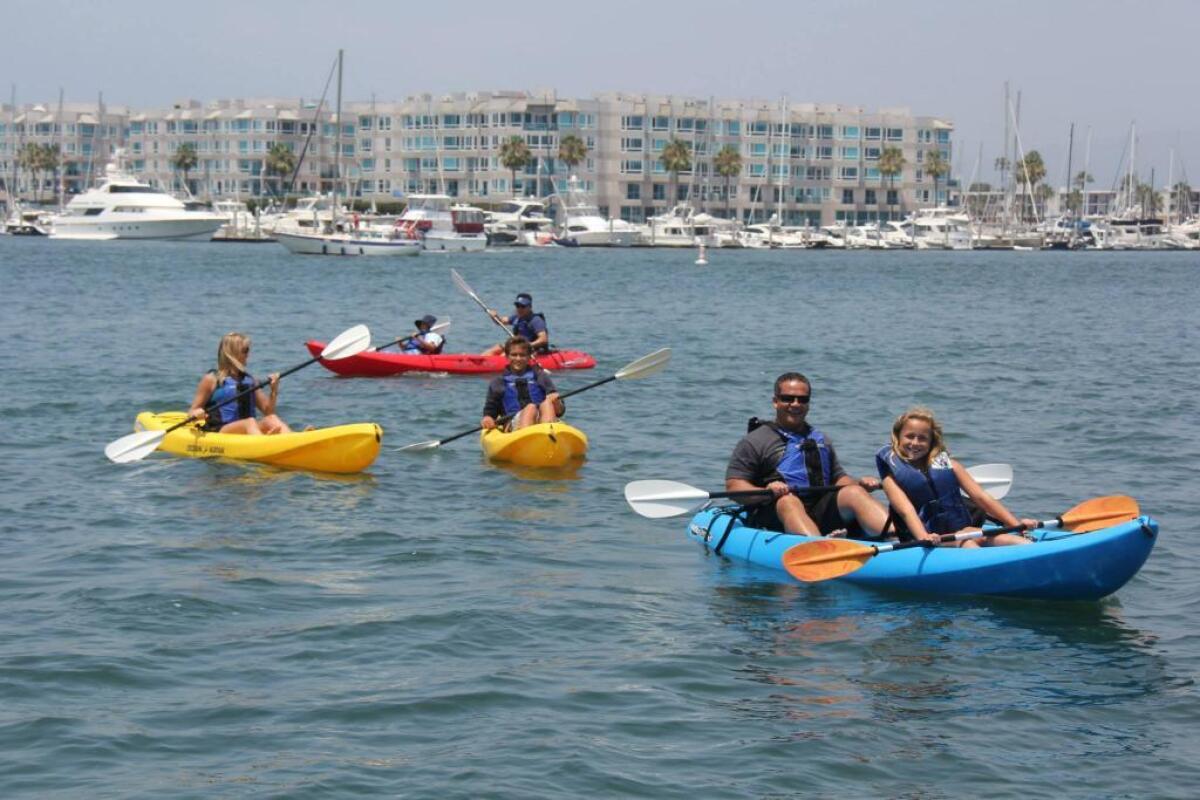 A group of people kayak in Marina del Rey.