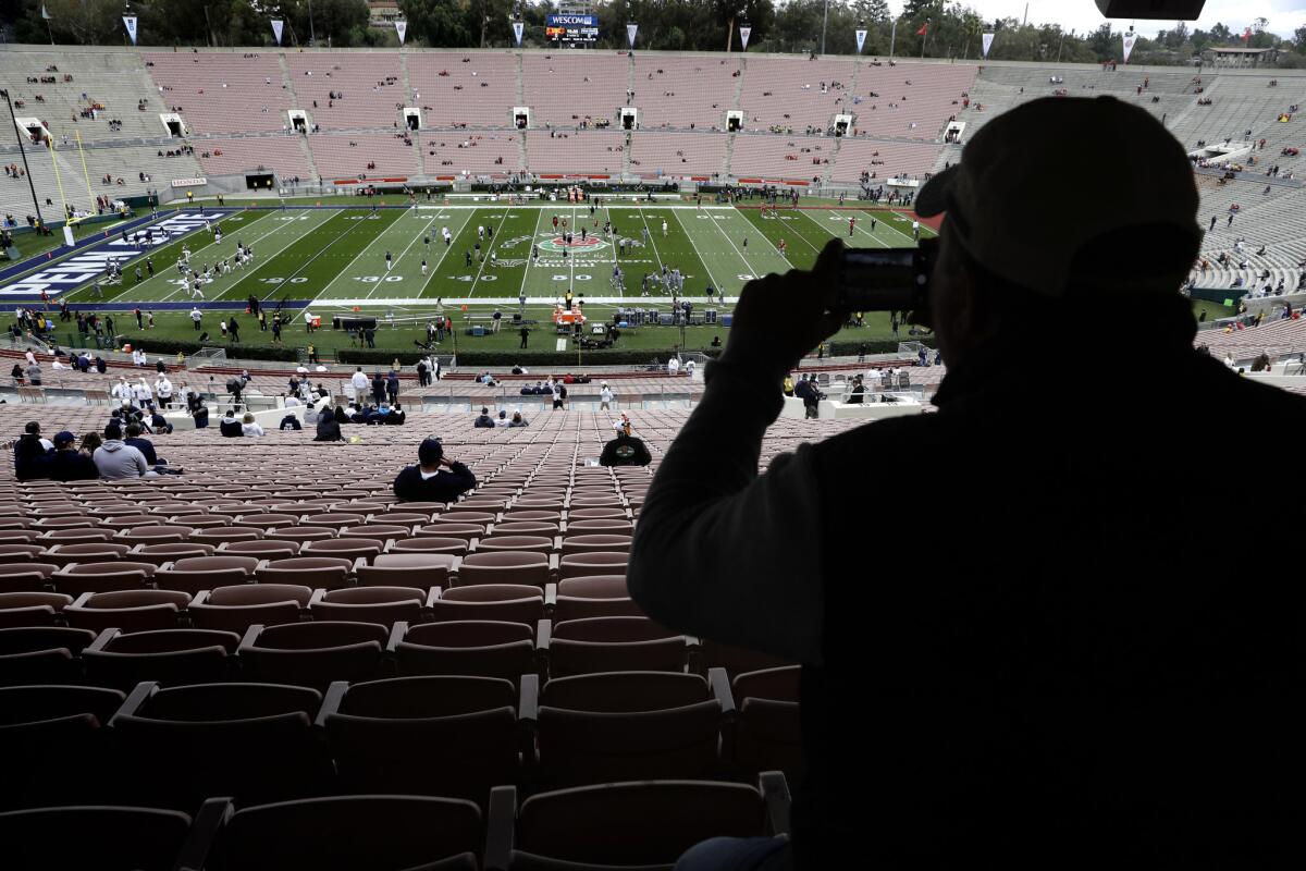 A spectator takes a picture of the field before the Rose Bowl game between USC and Penn State on Jan. 2.