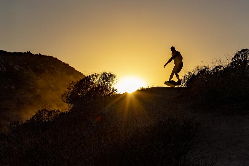 RIVERSIDE, CA - SEPTEMBER 27, 2022: A man on a Hoverboard takes advantage of the slight drop in temperatures as the sun sets at Challen Park on September 27, 2022 in Riverside, California. The September heat wave brought triple-digit temps to the Inland Empire as the National Weather Service issued heat warnings for Southern California for the week.(Gina Ferazzi / Los Angeles Times)