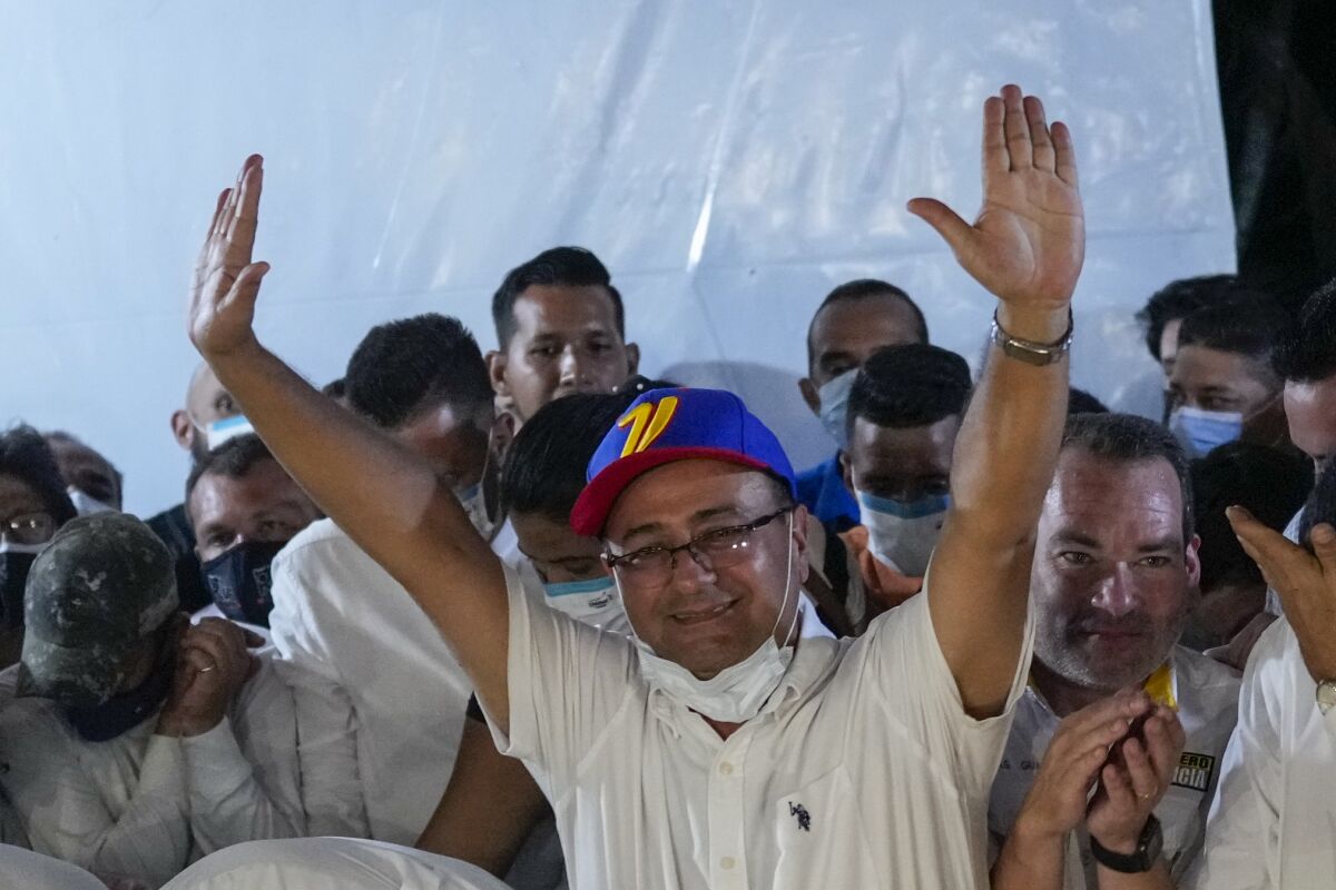 Venezuelan gubernatorial candidate lifting his arms in triumph
