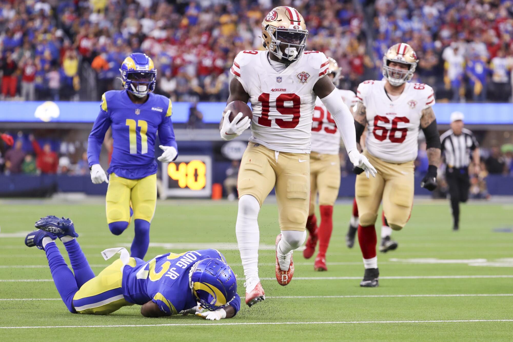 San Francisco 49ers wide receiver Deebo Samuel runs past Los Angeles Rams cornerback David Long Jr..