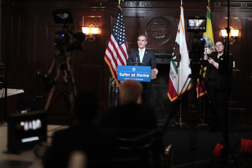 Los Angeles Mayor Eric Garcetti delivers his daily coronavirus briefing Thursday to cameras only as reporters listen via teleconference at City Hall. 