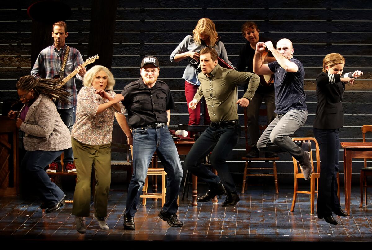 The ensemble cast of "Come From Away" portrays airline passengers diverted from their destination on 9/11 and the small-town Canadians who took them in.
