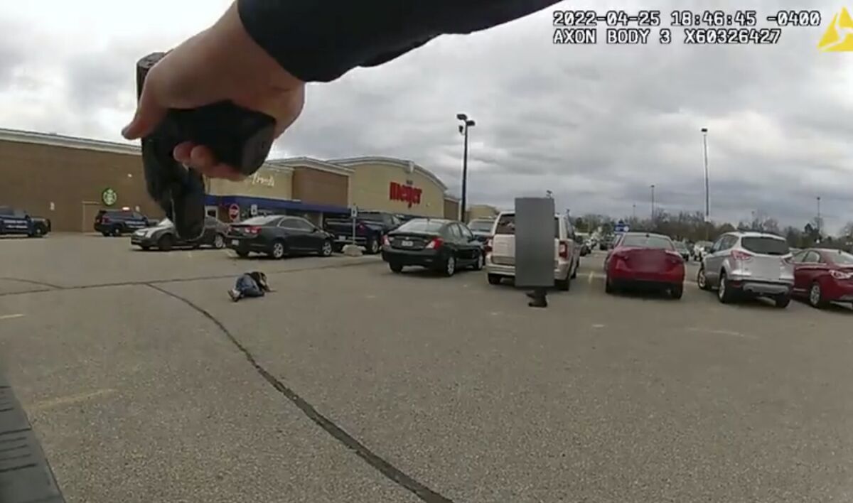 In this image taken from police body camera video released by the East Lansing Police, DeAnthony VanAtten lays on the ground after being shot by East Lansing, Mich., police on April 25, 2022, while responding to a call about a shopper with a gun. Police released video of the incident Thursday, May 5, 2022. State police are investigating the shooting. DeAnthony VanAtten’s injuries were not life-threatening. (East Lansing Police via AP)