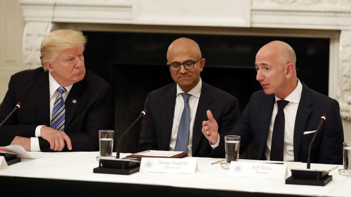 President Trump and Microsoft CEO Satya Nadella, center, listen to Amazon CEO Jeff Bezos speak at the White House in 2017.