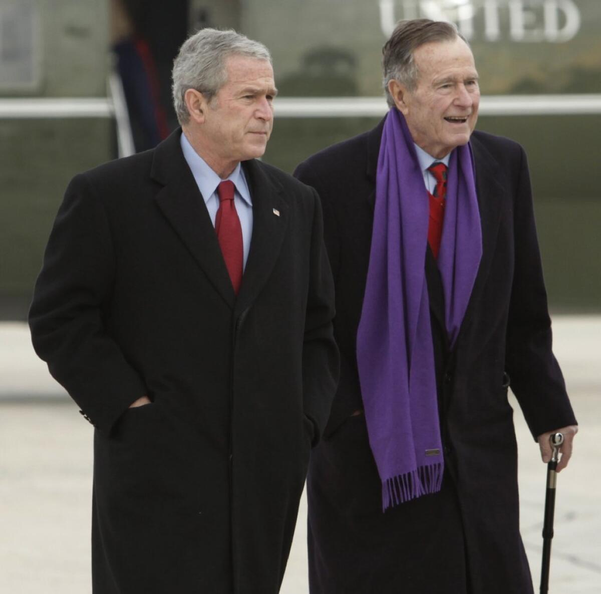 Private photos of presidents George W. Bush, left, and his father George H.W. Bush were hacked and put online.