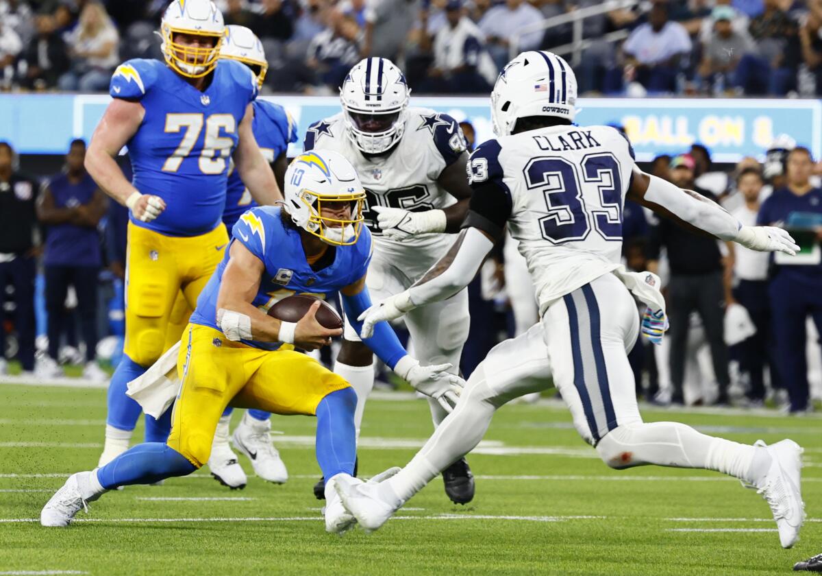 Chargers quarterback Justin Herbert scrambles against the Dallas Cowboys in the first half.