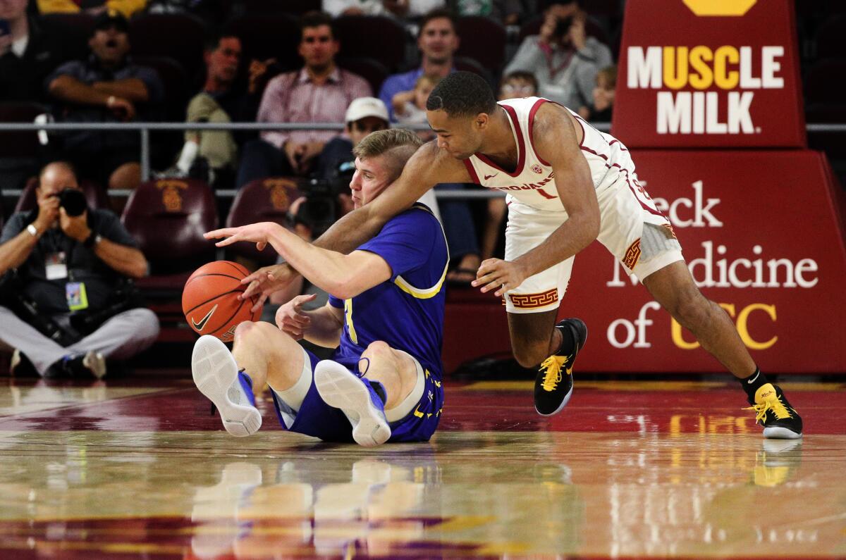 USC guard Elijah Weaver tries to steal the ball away from South Dakota State guard Baylor Scheierman.
