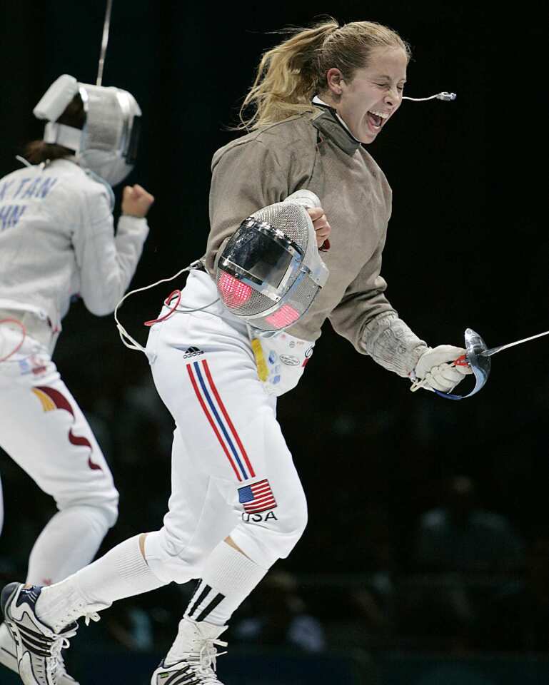 Mariel Zagunis celebrates after defeating Tan Xue of China to win the gold medal in women's individual sabre at the 2004 Olympics in Greece. Zagunis will go for a third straight sabre fencing gold medal in London; her 2004 Olympic win ended a 100-year U.S. drought.