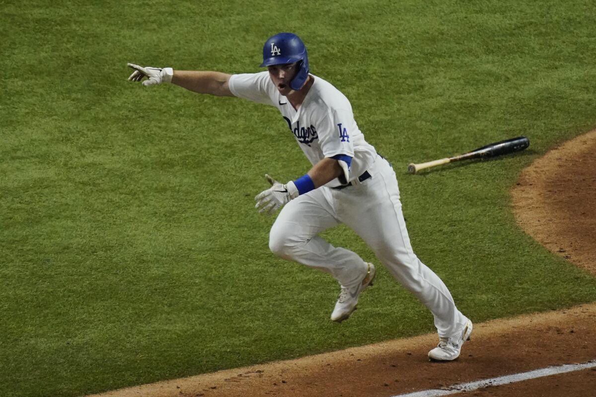 Dodgers catcher Will Smith celebrates after hitting a two-run single against the Atlanta Braves in Game 7 of the NLCS.