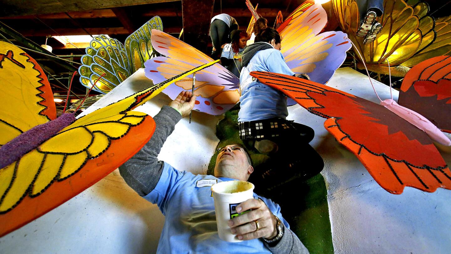 Wayne Winkel paints Donate Life's "The Never Ending Story" float at the Rosemont Pavilion in Pasadena. Winkel, who is from Michigan, is working in memory of his son, Christopher, who died at the age of 26.