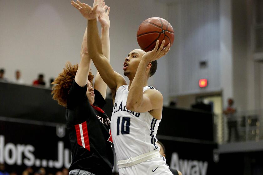 Amari Bailey (10) of Sierra Canyon drives to the basket guarded by Brantly Stevenson (4) of Etiwanda.