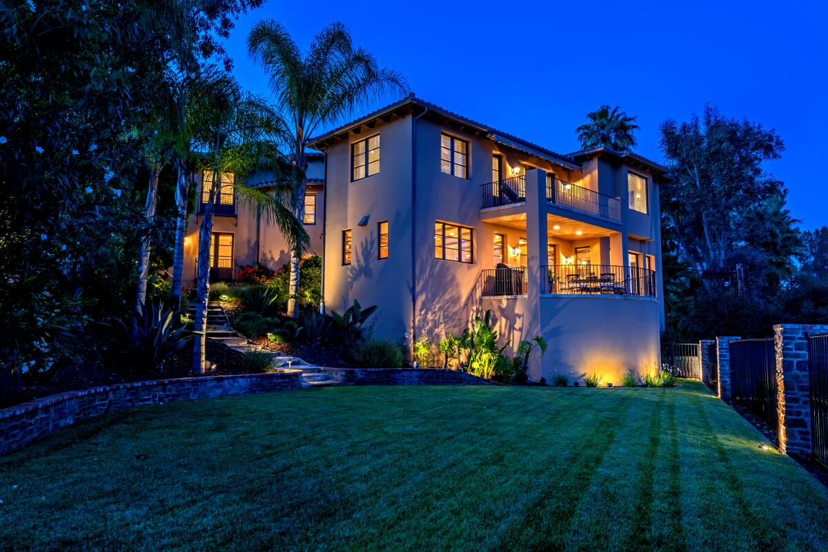 Overlooking the lake, the Mediterranean villa-style house makes good use of the scenery with six separate patios.