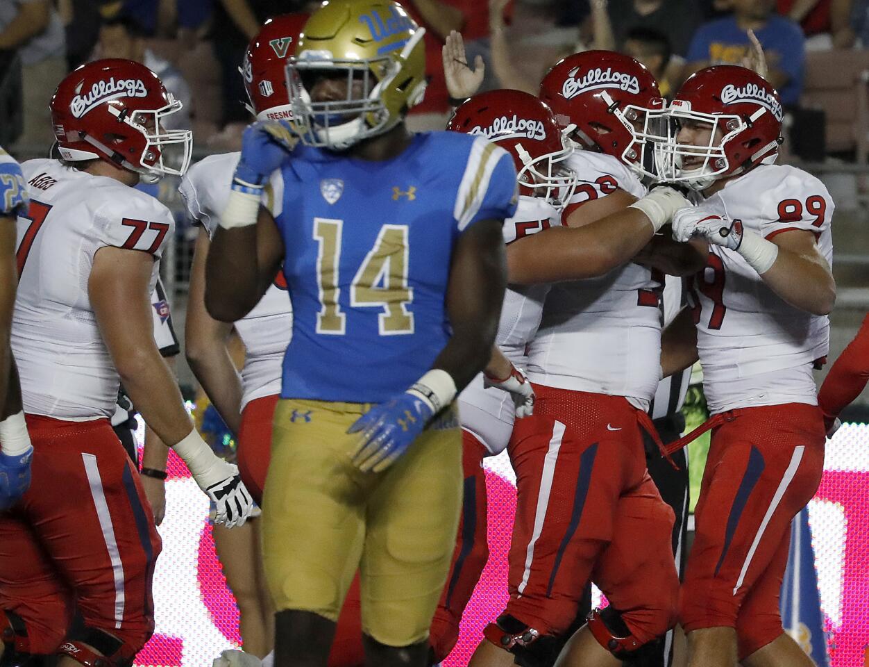 Fresno State tight end Kyle Riddering, right, is congratulated by teammates after making a touchdown catch against UCLA in the first quarter on Saturday.