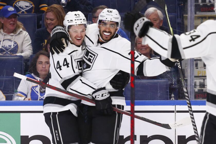 Los Angeles Kings center Andreas Athanasiou (22) celebrates his goal with defenseman Mikey Anderson (44) during the second period of an NHL hockey game against the Buffalo Sabres, Sunday, March 6, 2022, in Buffalo, N.Y. (AP Photo/Jeffrey T. Barnes)