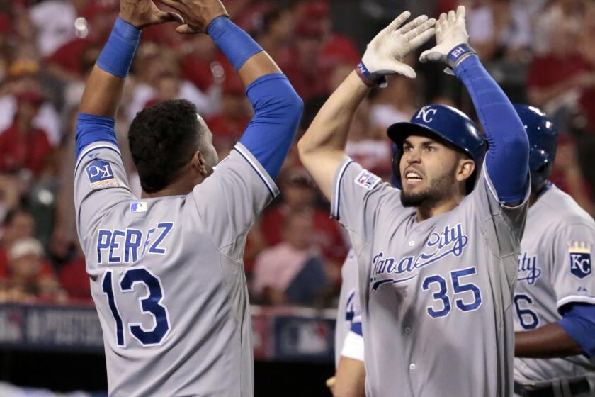 Kansas City's Eric Hosmer, right, celebrates with teammate Salvador Perez after hitting a two-run home run in the 11th inning. The Royals beat the Angels, 4-1.