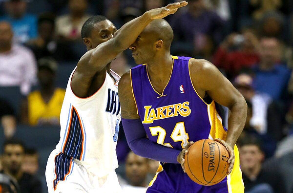 Bobcats guard Ben Gordon blocks the vision of Lakers guard Kobe Bryant during their game at Time Warner Cable Arena on Saturday evening.