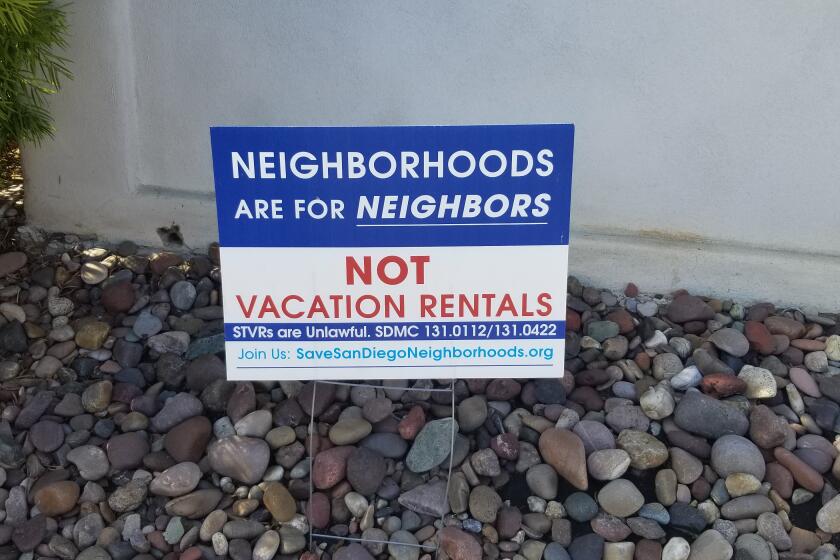 A sign placed in a yard in Pacific Beach speaks to the feelings many community members have against short-term vacation rentals.