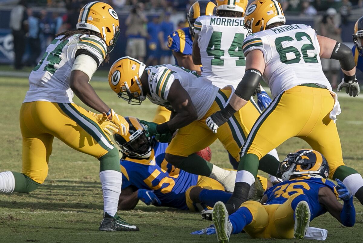 Packers kick returner Ty Montgomery (88) has the ball stripped from him by Rams linebacker Ramik Wilson, who recoverd the fumble, late in the fourth quarter.