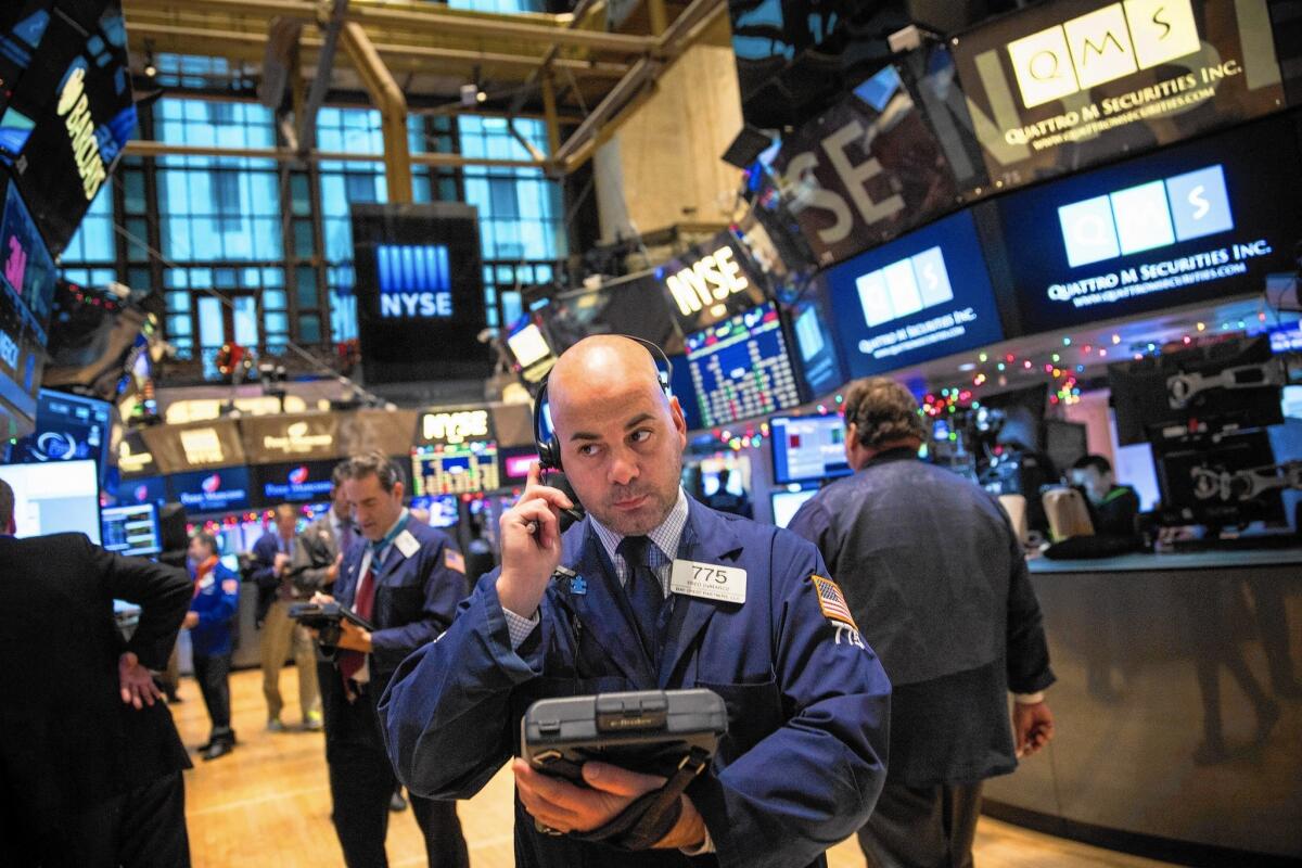 Traders work on the floor of the New York Stock Exchange on the first trading day of 2015.