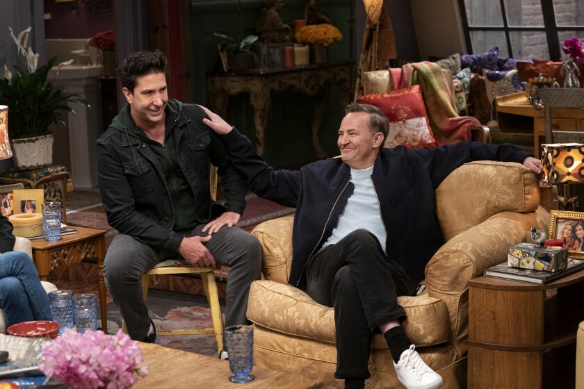 David Schwimmer and Matthew Perry joke around on a TV show set.
