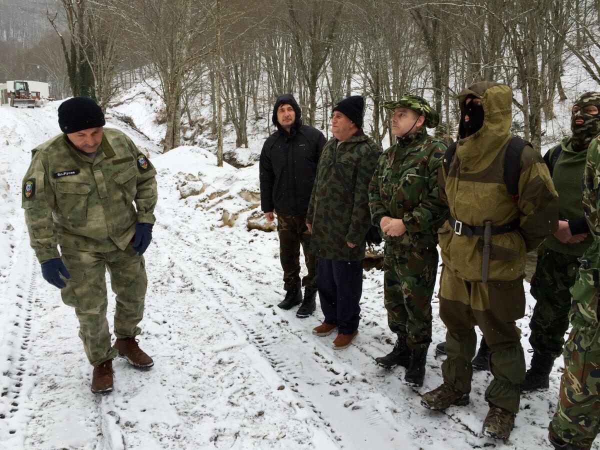 Vladimir Rusev, left, surveys members of his volunteer force at a training session near the Turkish border in February.