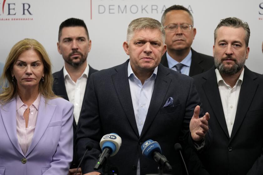 Chairman of Smer-Social Democracy party Robert Fico, center, adresses the results of an early parliamentary election during a press conference in Bratislava, Slovakia, Sunday, Oct. 1, 2023. (AP Photo/Darko Bandic)