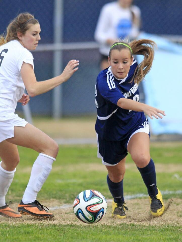 Newport Harbor High's Allyson Nordlie, right, changes directions on Corona del Mar's Maddison Roberts, left, during the second half in the Battle of the Bay match on Tuesday.
