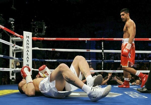 Amir Khan heads to a neutral corner after knocking down Marcos Maidana in the second round of their WBA junior-welterweight championship bout on Saturday in Las Vegas.