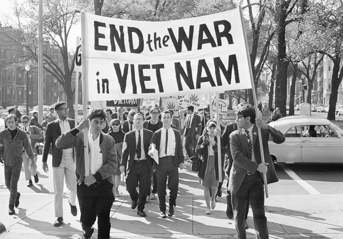 FILE - College students from various nearby schools march down Commonwealth Avenue in Boston on Oct. 16, 1965 to attend rally on Boston Common protesting U.S. involvement in Vietnam. They’re hallmarks of American history: protests, rallies, sit-ins, marches, disruptions. They date from the early days of what would become the United States to the sights and sounds currently echoing across the landscapes of the nation’s colleges and universities. (AP Photo/Frank C. Curtin, File)