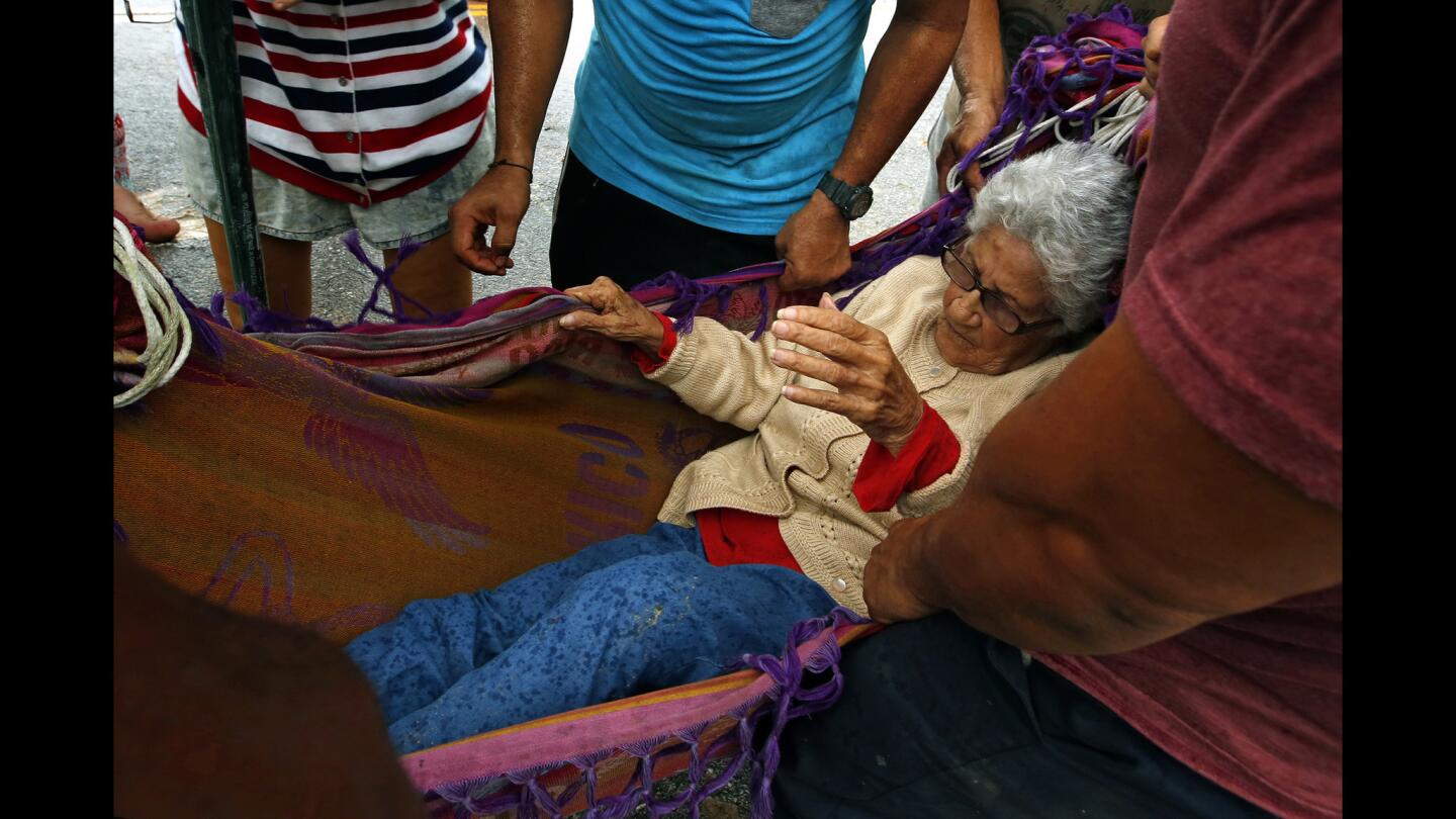 Delia Pineda, 89, is evacuated from Salto Arriba, an area cut off from Utuado following Hurricane Maria.