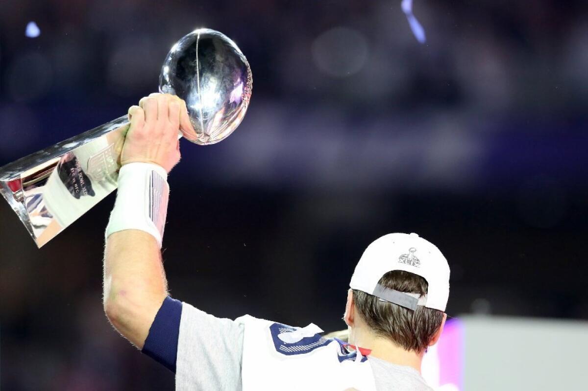 New England Patriots quarterback Tom Brady hoists the Lombardi trophy after his team defeated the Seattle Seahawks in the Super Bowl on Sunday.