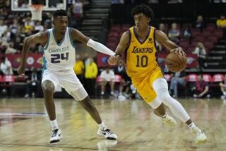 Los Angeles Lakers' Max Christie drives against Charlotte Hornets' Brandon Miller during the second half of an NBA summer league basketball game Sunday, July 9, 2023, in Las Vegas. (AP Photo/John Locher)