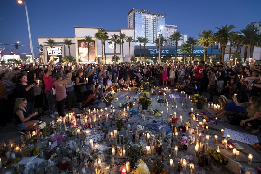 LAS VEGAS, NV - OCTOBER 8: Mourners hold their candles in the air during a moment of silence during a vigil to mark one week since the mass shooting at the Route 91 Harvest country music festival, on the corner of Sahara Avenue and Las Vegas Boulevard at the north end of the Las Vegas Strip, on October 8, 2017 in Las Vegas, Nevada. On October 1, Stephen Paddock killed 58 people and injured more than 450 after he opened fire on a large crowd at the Route 91 Harvest country music festival. The massacre is one of the deadliest mass shooting events in U.S. history. (Photo by Drew Angerer/Getty Images) ** OUTS - ELSENT, FPG, CM - OUTS * NM, PH, VA if sourced by CT, LA or MoD **