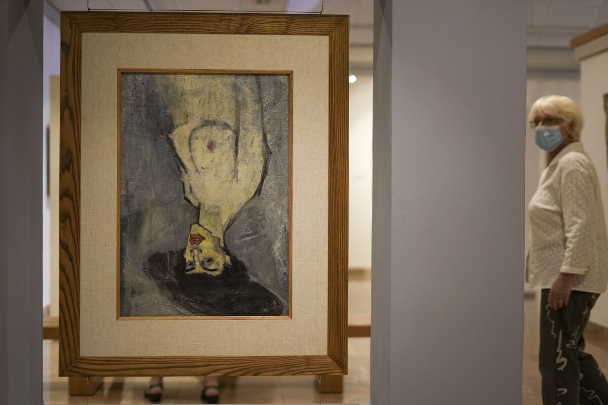 Amadeo Modigliani's 1908 "Nude with a Hat," is hung upside down because another painting by him, "Maud Abrantes," on the reverse side of the same canvas is oriented correctly, while on display at Haifa University's Hecht Museum in Haifa, Israel, June 28, 2022. Curators at the museum using x-ray technology have discovered three previously unknown sketches by the celebrated 20th century artist hiding beneath the surface of the painting. (AP Photo/Ariel Schalit)