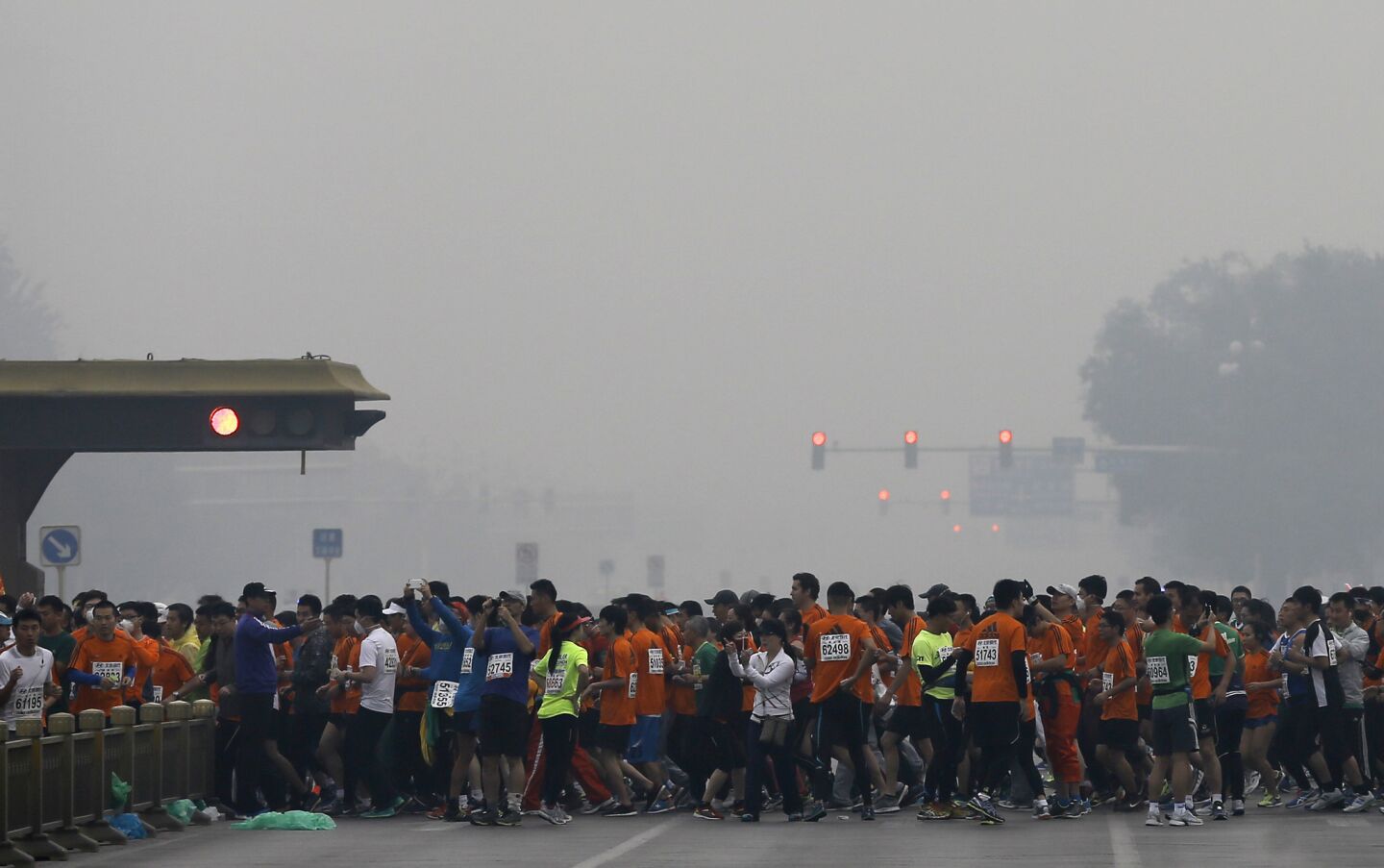 Runners jog past Chang'an Avenue near Tiananmen Square on Oct. 19.