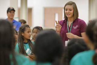 SAN MARCOS, CA: April 13, 2018: Justine Panian service leader for San Marcos leads a group of Daisy, Brownie, and Junior Girl Scouts in song during a meeting at San Marcos Elementary School. Justine, and her mom, Kassie Panian, are pioneering a new program to expand Girl Scouts by encouraging Cal State San Marcos college students through outreach to become troop leaders. The innovative program may soon go national. Photo by Howard Lipin/San Diego Union-Tribune/Mandatory Credit: HOWARD LIPIN SAN DIEGO UNION-TRIBUNE/ZUMA PRESS