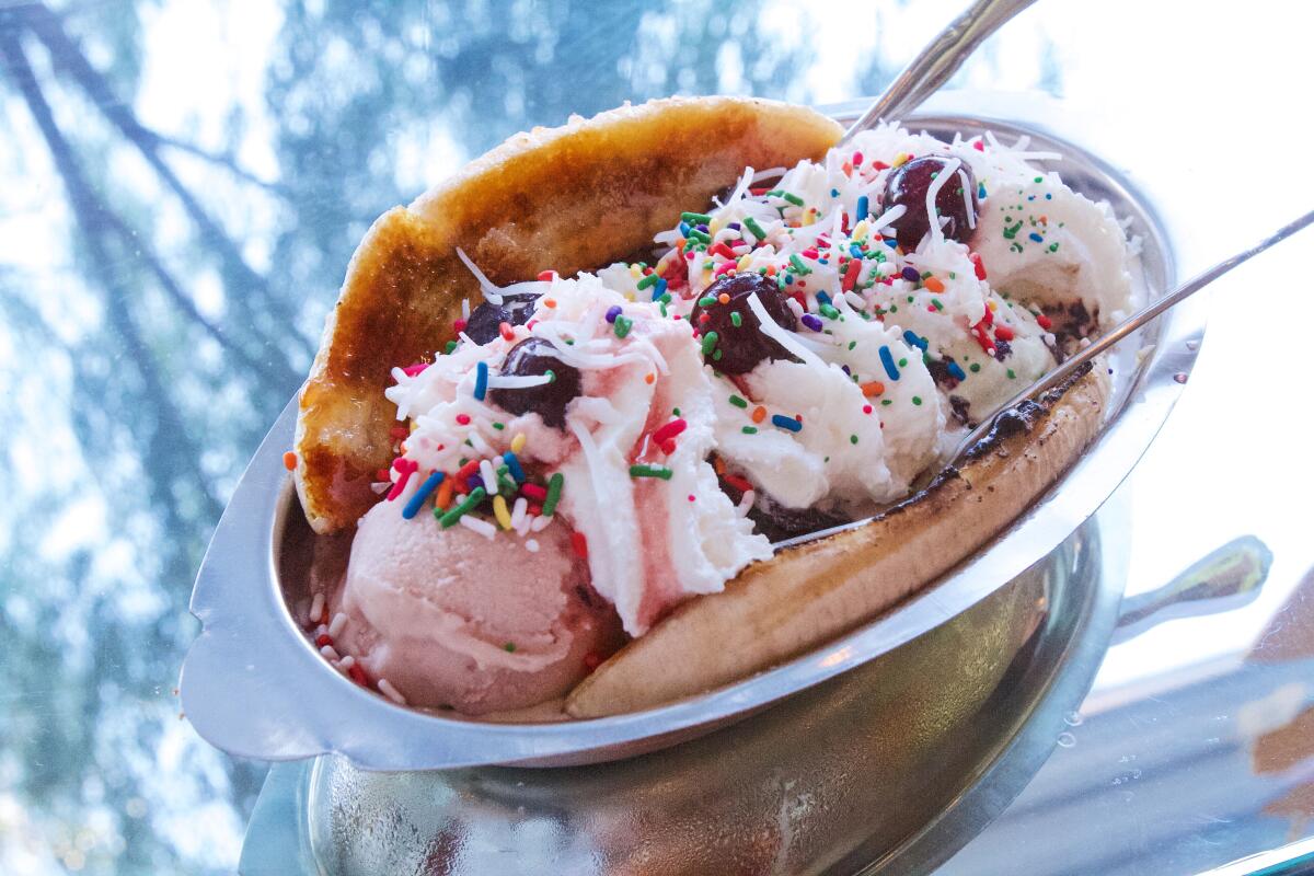 A br?léed banana split sits on a mirrored bar at Echo Park ice cream parlor Fluffy McCloud's 