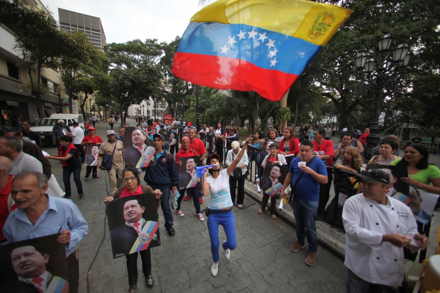 Supporters of Venezuela's President Hugo Chavez celebrate his return to the country at Bolivar Square in Caracas.