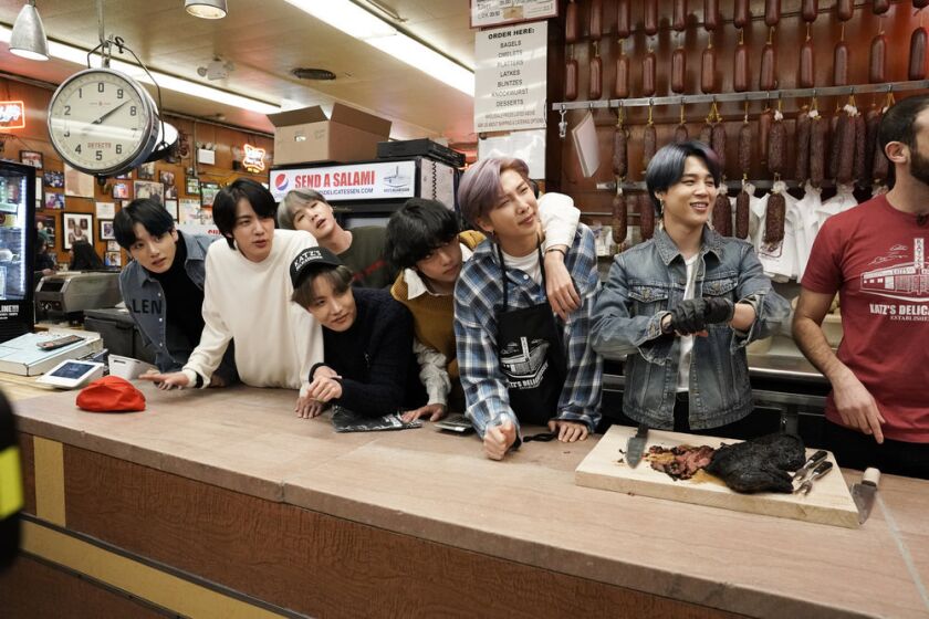 The members of BTS — from left, Jungkook, Jin, SUGA (behind), J-Hope (front), V, RM, and Jimin — inside New York's Katz Deli on "The Tonight Show Starring Jimmy Fallon."