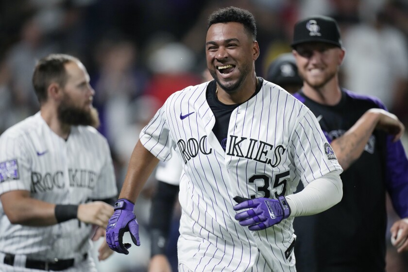Colorado Rockies' Elias Diaz celebrates after his game-ending, three-run home run off St. Louis Cardinals relief pitcher Giovanny Gallegos during the ninth inning of a baseball game Thursday, July 1, 2021, in Denver. The Rockies won 5-2. (AP Photo/David Zalubowski)