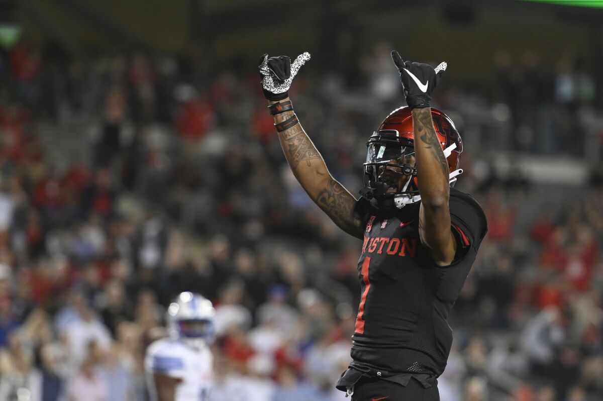 Houston wide receiver Nathaniel Dell celebrates his touchdown during the second half of an NCAA college football game against SMU on Saturday, Oct. 30, 2021, in Houston. (AP Photo/Justin Rex)